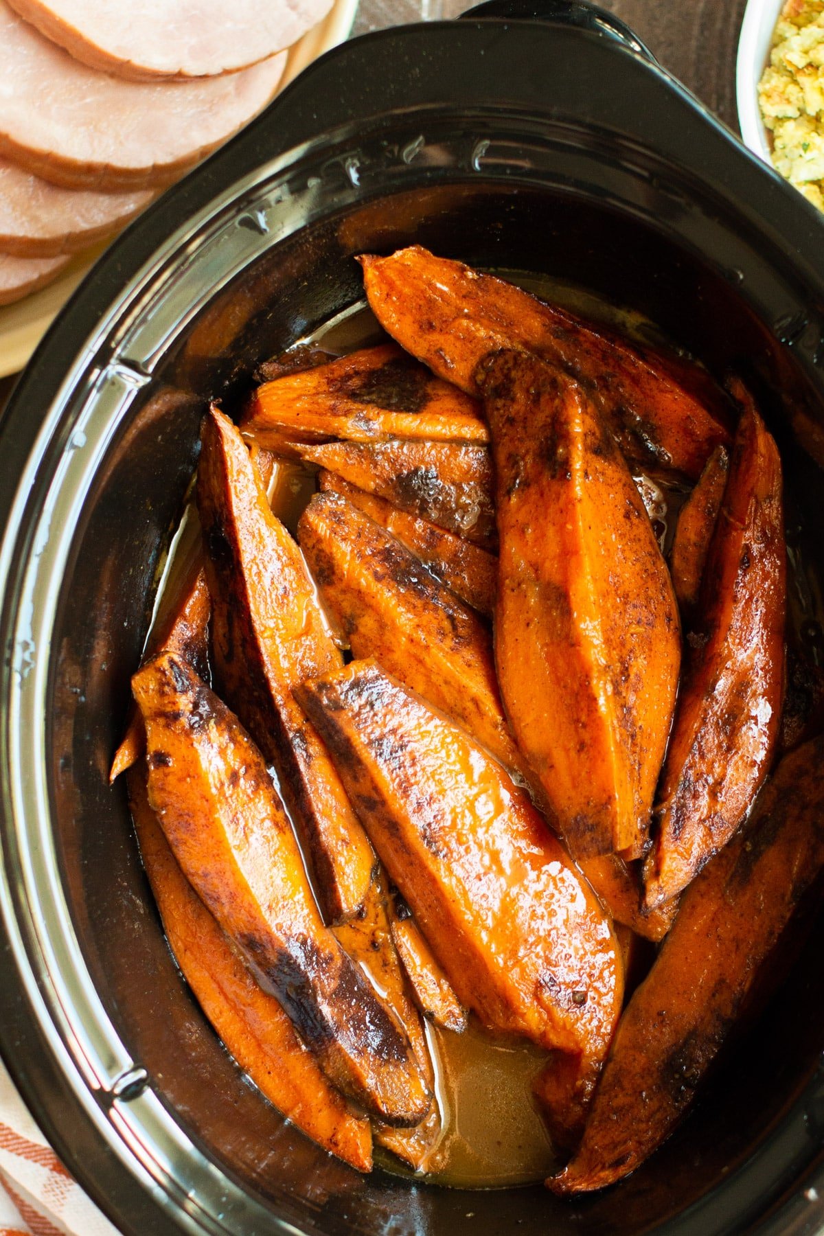 close up of sweet potatoes wedges in a slow cooker