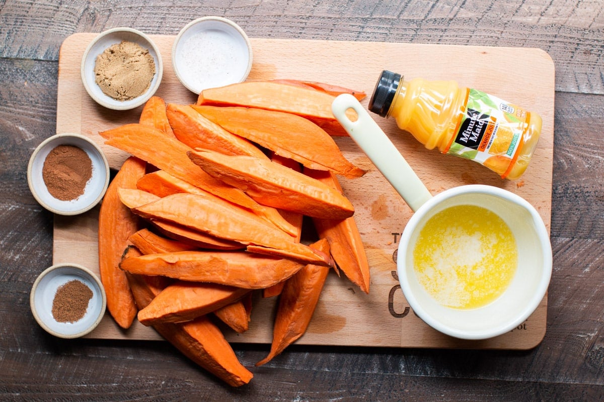 Ingredients for sweet potato wedges on a cutting board
