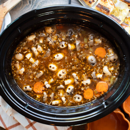 slow cooker full of stew with ground beef, carrots and mushrooms