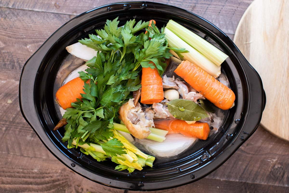 Turkey pieces, parsley, carrots, celery, onion, water and bay leaves in a slow cooker