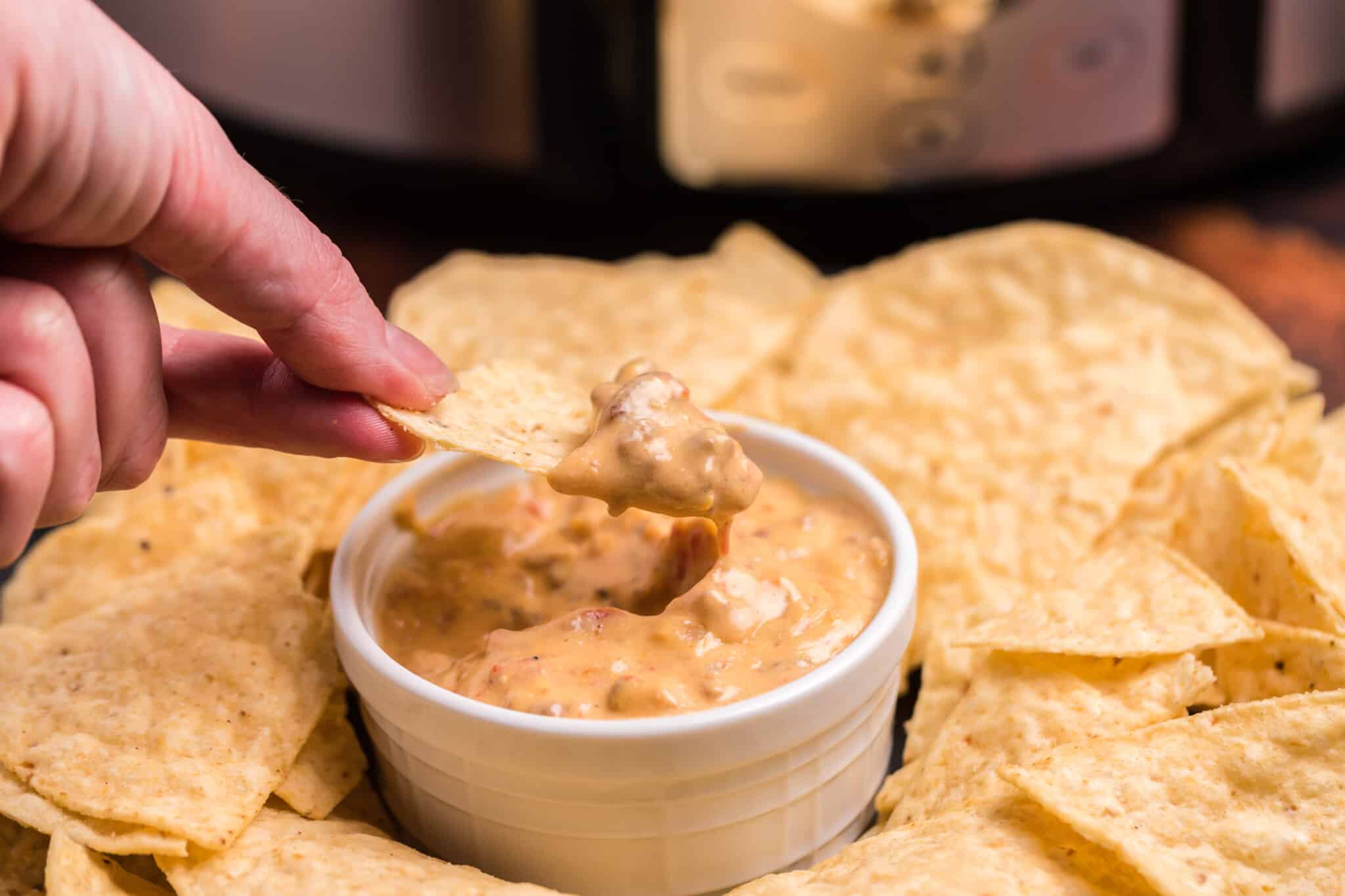 chip dipping bacon cheeseburger dip.