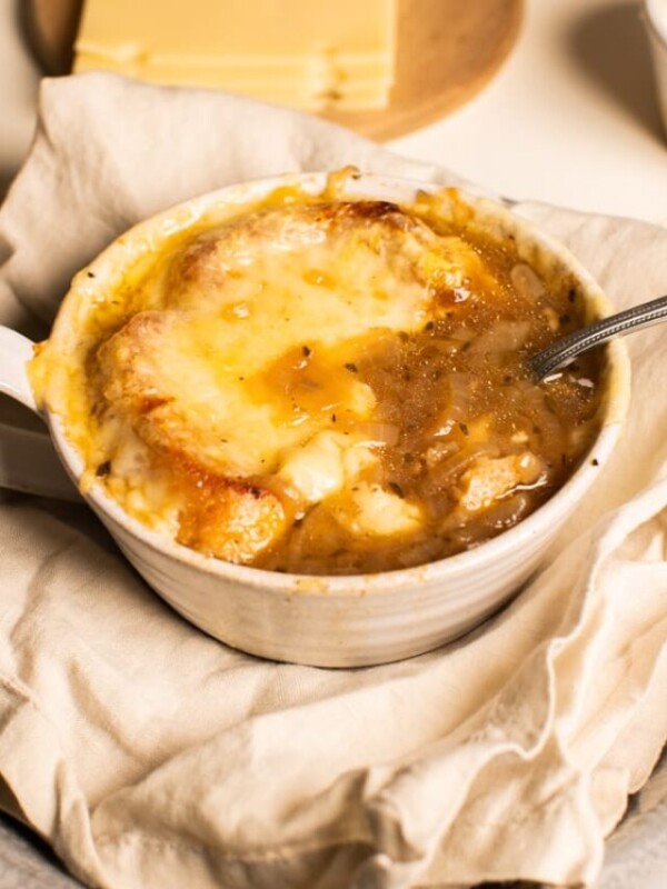 bowl of french onion soup with cheese on top.