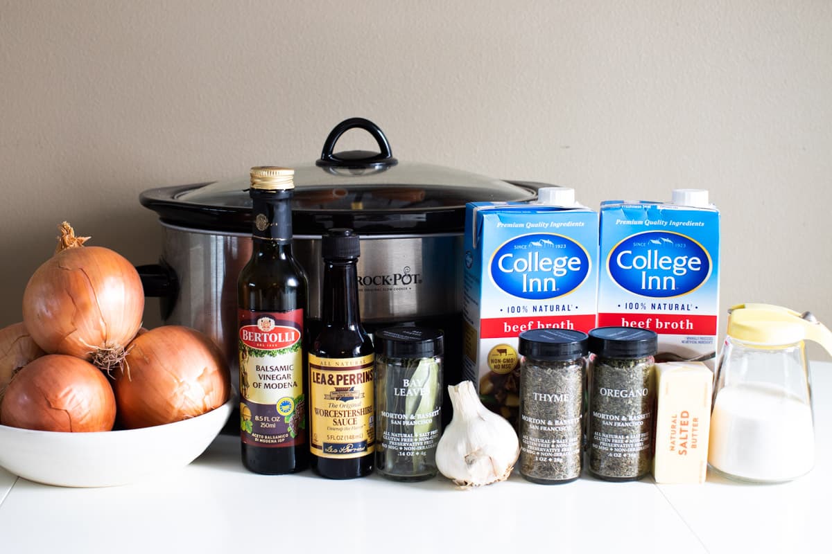 ingredients for french onion soup in front of a slow cooker