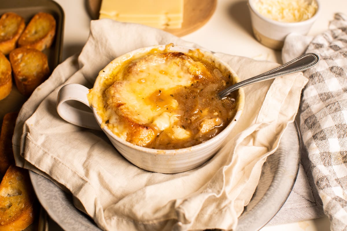 french onion soup with spoon in it.