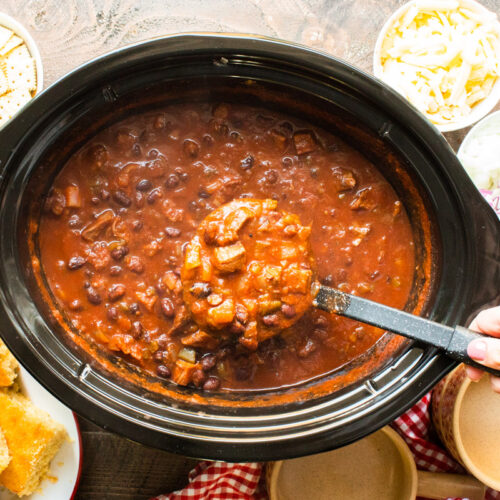 prime rib chili being scooped out of slow cooker