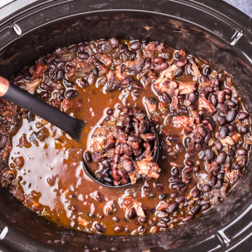 black bean soup on ladle in slow cooker