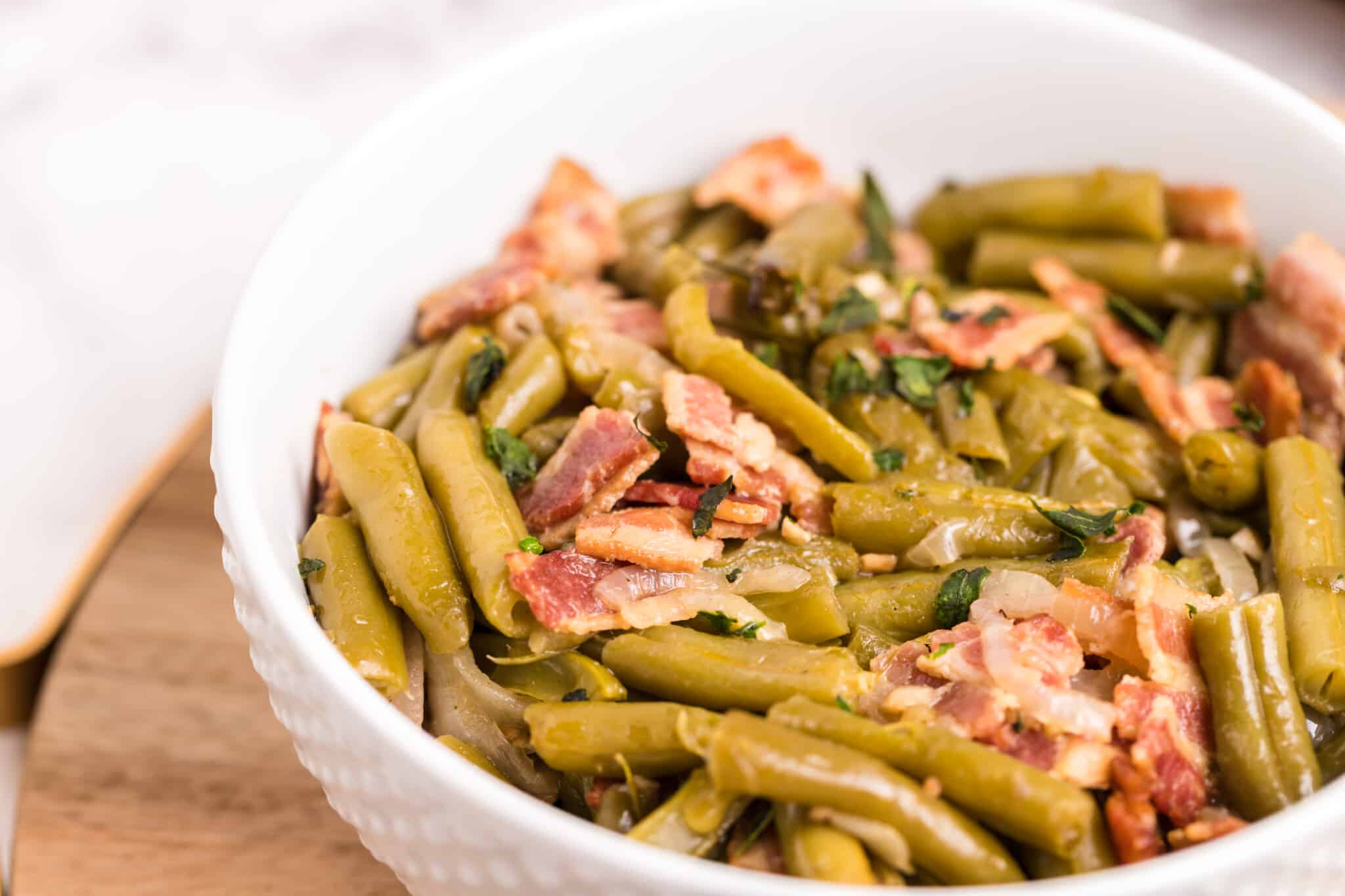 white bowl with green beans in it