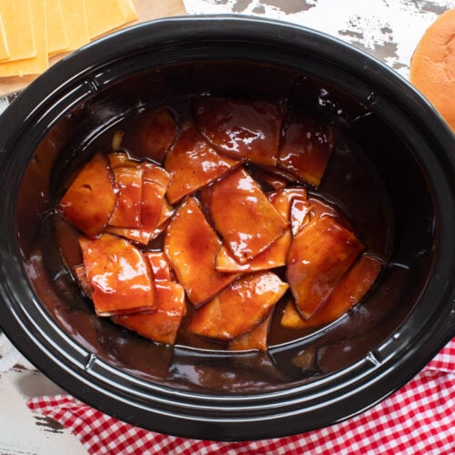 cooked ham in barbecue sauce in slow cooker