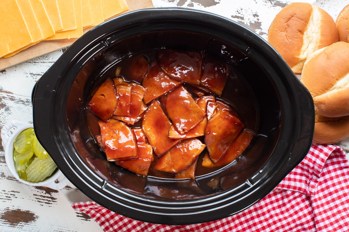 cooked ham in barbecue sauce in slow cooker