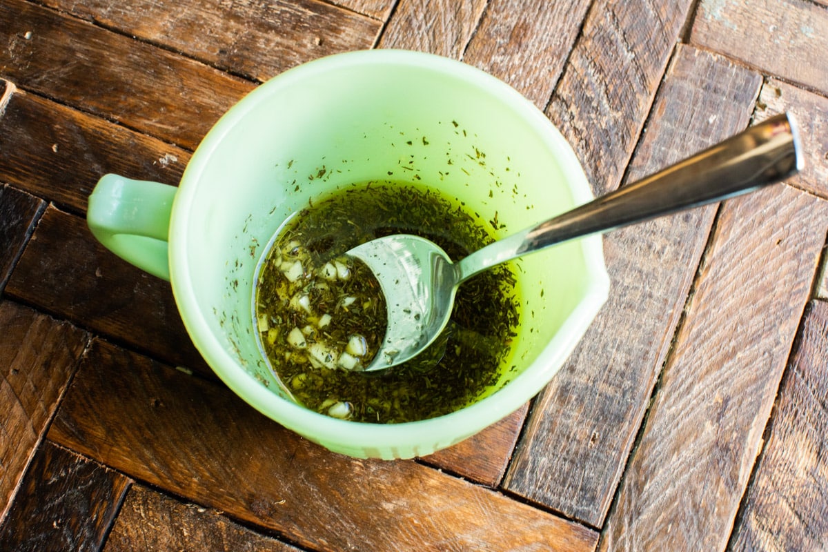 oil, seasoning and garlic in green bowl