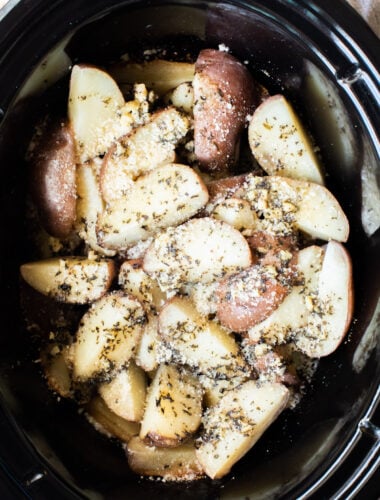 Close up of cooked garlic parmesan potatoes in slow cooker