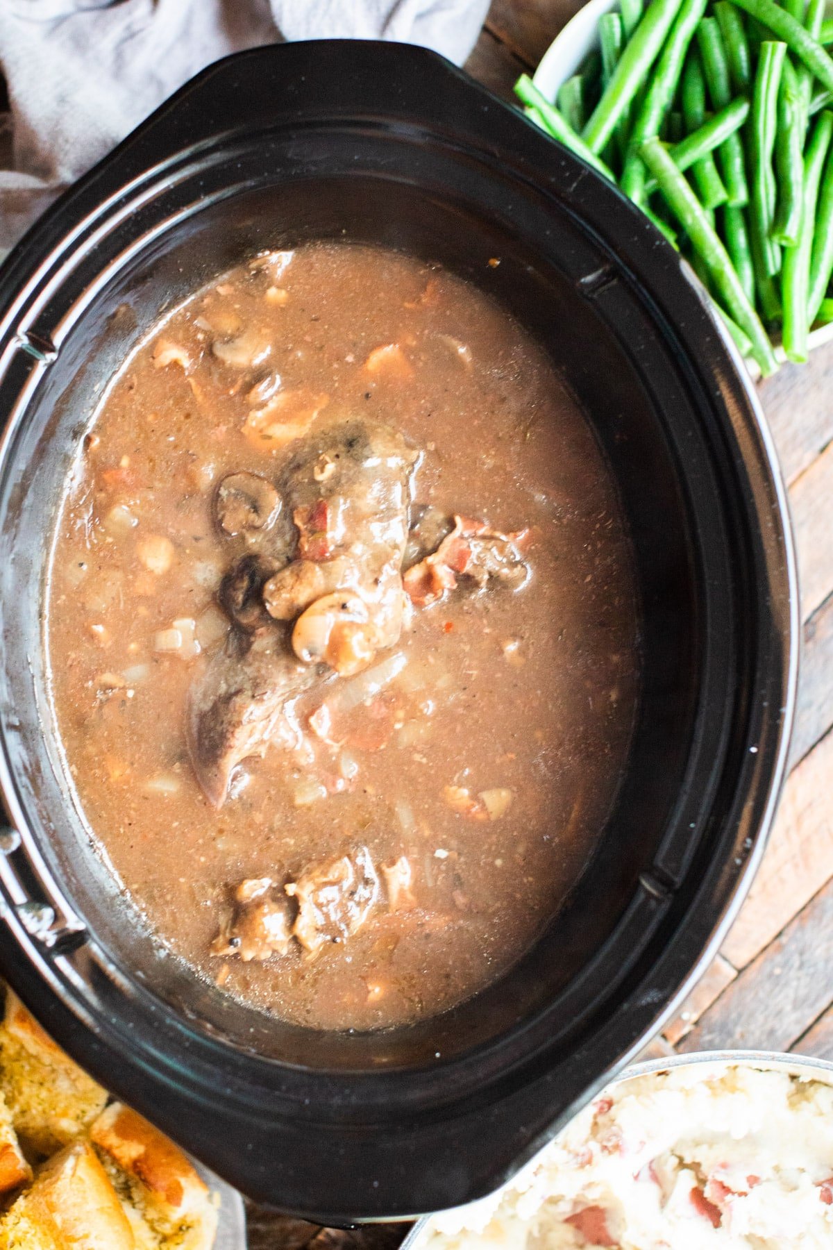 cooked venison roast in mushroom bacon gravy