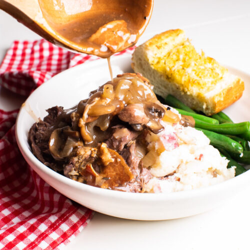 gravy being poured over venison roast