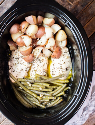 close up photo of chicken, potatoes and green beans in slow cooker