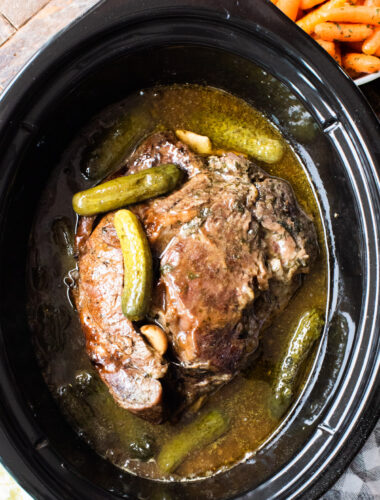 cooked chuck roast with pickles on top