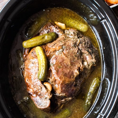 cooked chuck roast with pickles on top