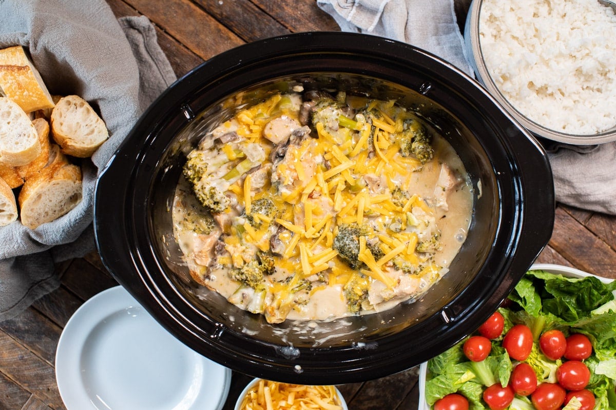 done cooking cheesy broccoli chicken in slow cooker with salad on the side.