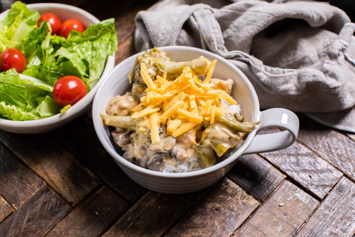 white bowl with cheesy broccoli chicken in it