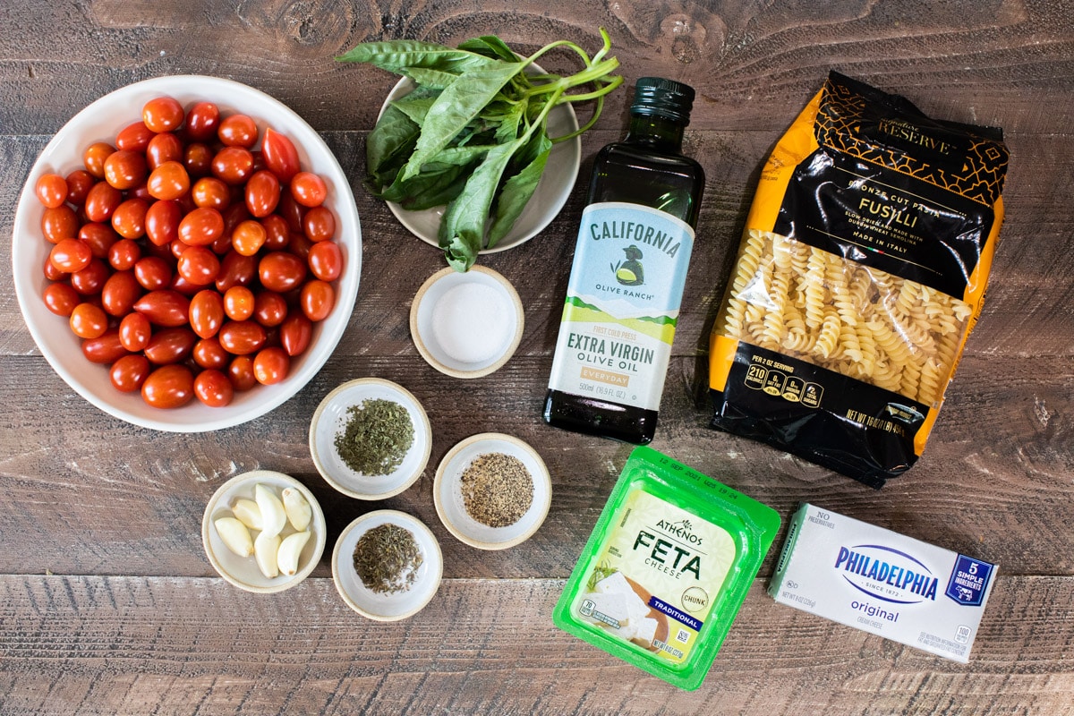 ingredients for feta tomato pasta on wooden table