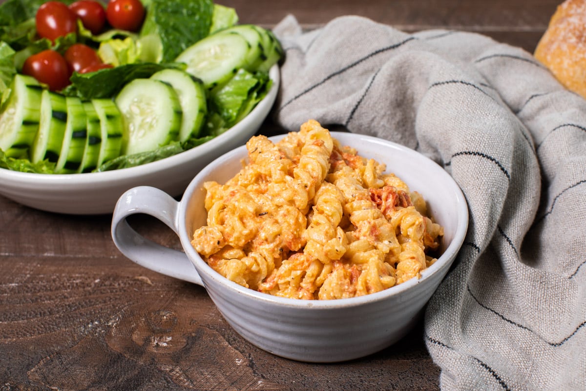 feta tomato pasta in a white bowl