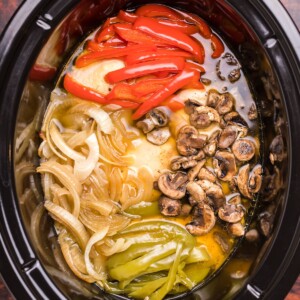 image of chicken, bell peppers, onions and mushrooms in slow cooker