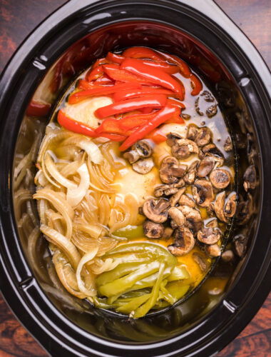 image of chicken, bell peppers, onions and mushrooms in slow cooker