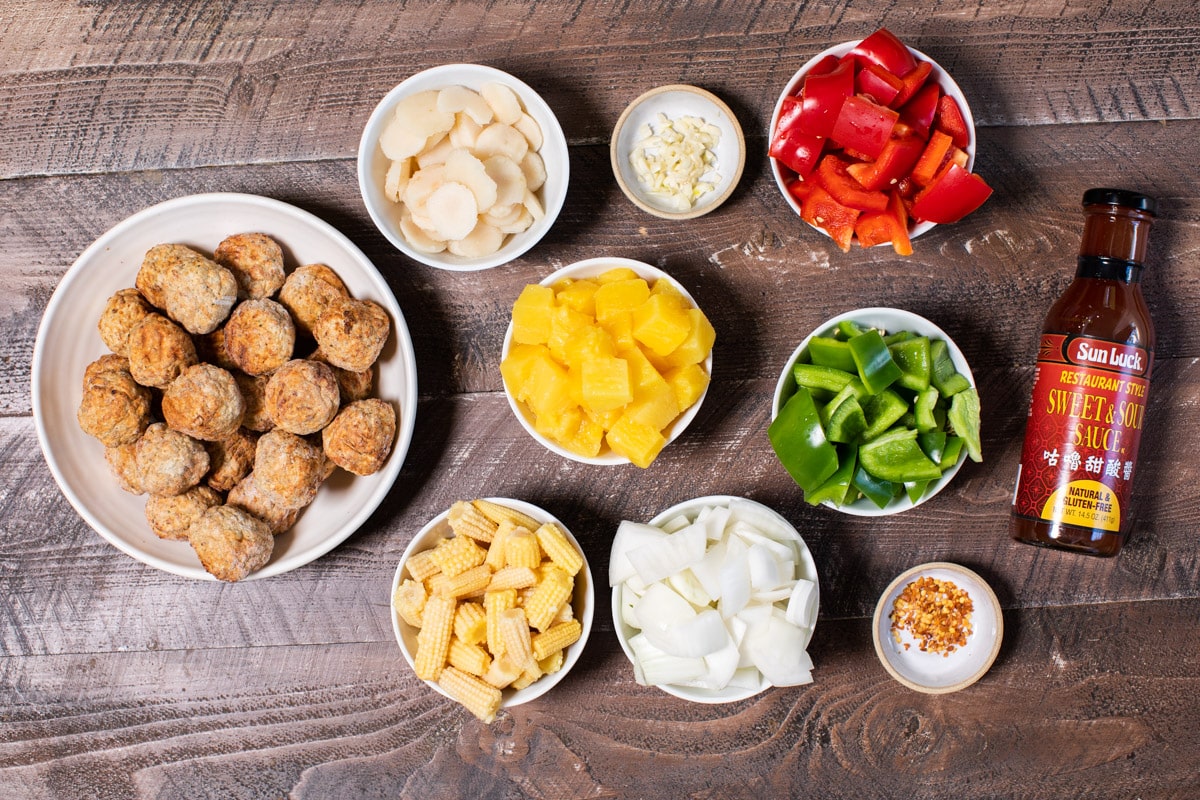 ingredients for sweet and sour meatballs in bowl on wooden table