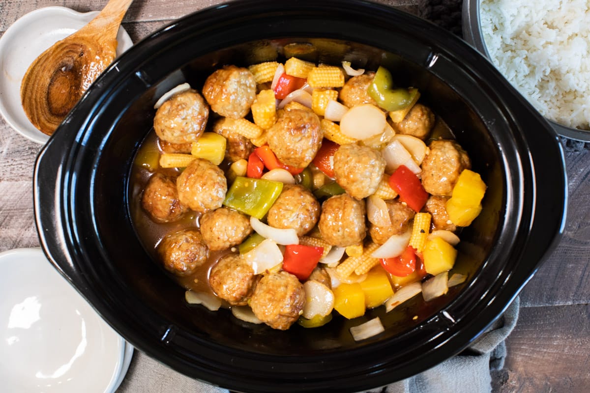 close up of sweet and sour meatballs done cooking in the slow cooker