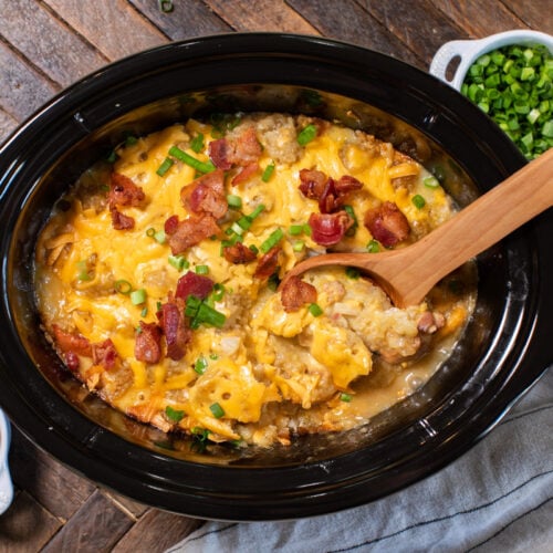 chicken tater tot casserole with bacon and green onions on top.