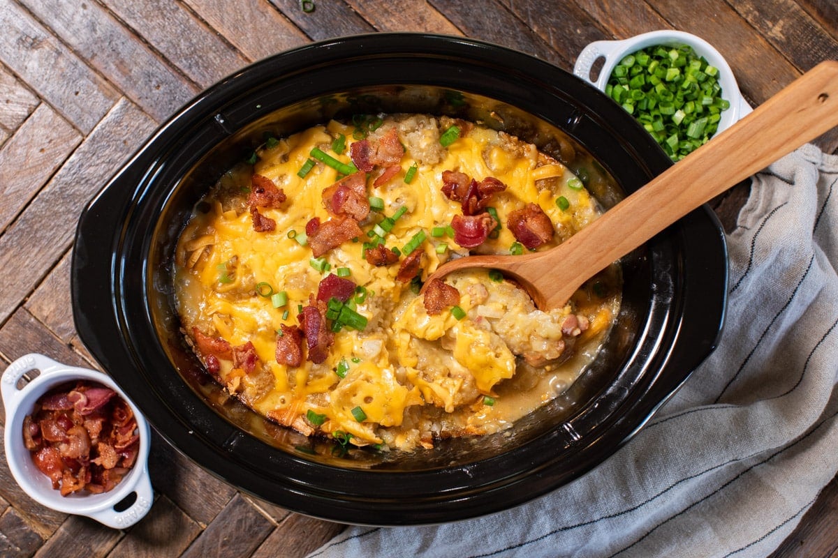 chicken tater tot casserole with bacon and green onions on top.