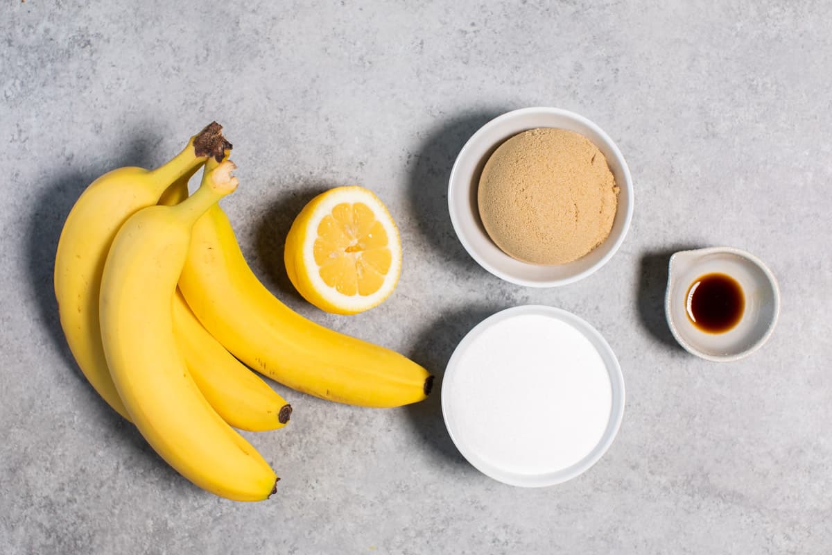 bananas, sugar, lemon and vanilla on table