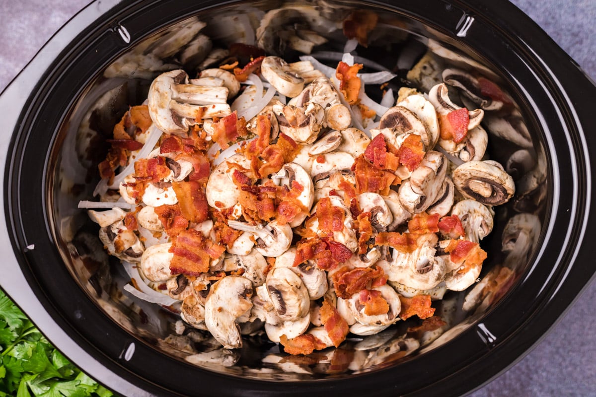 chicken, mushroom, bacon and onion in a slow cooker