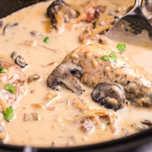 close up of chicken marsala in slow cooker with parsely on top.