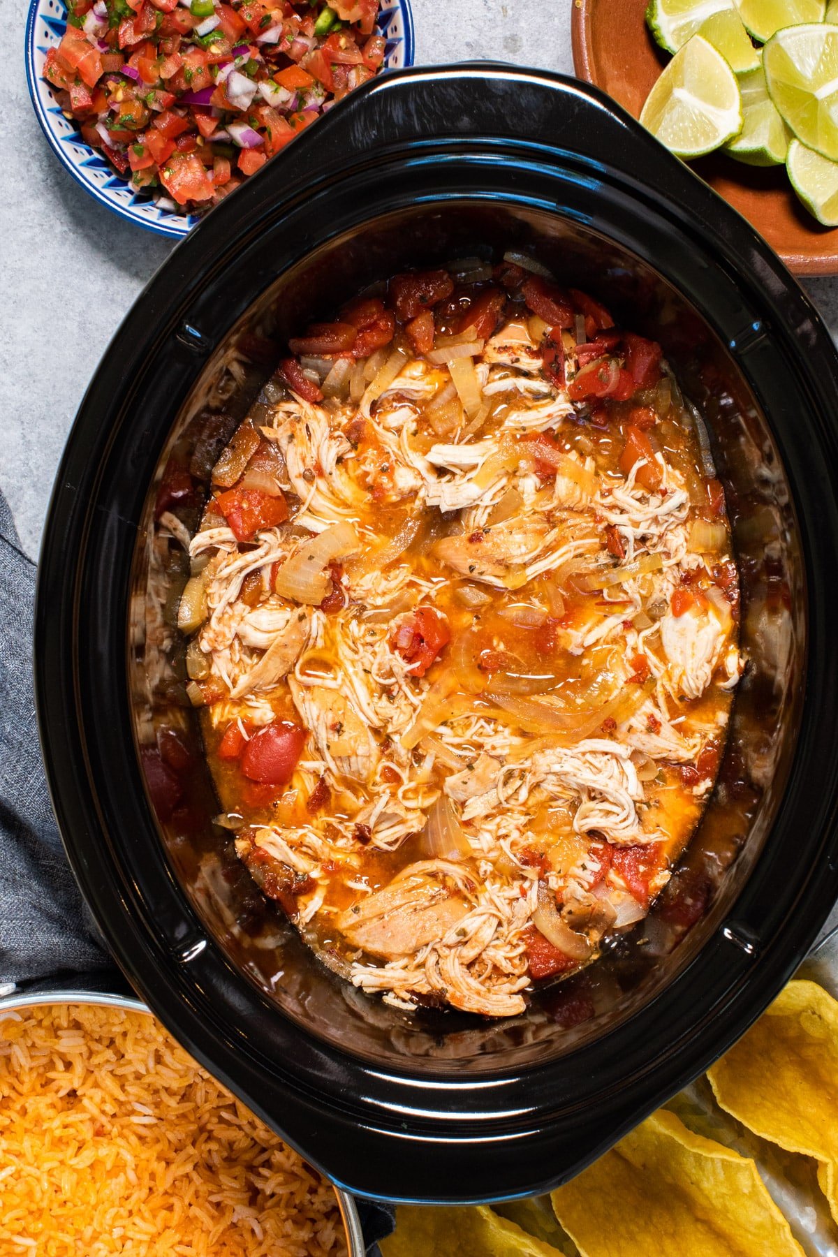 Chicken tinga in slow cooker with rice and salsa on the side.