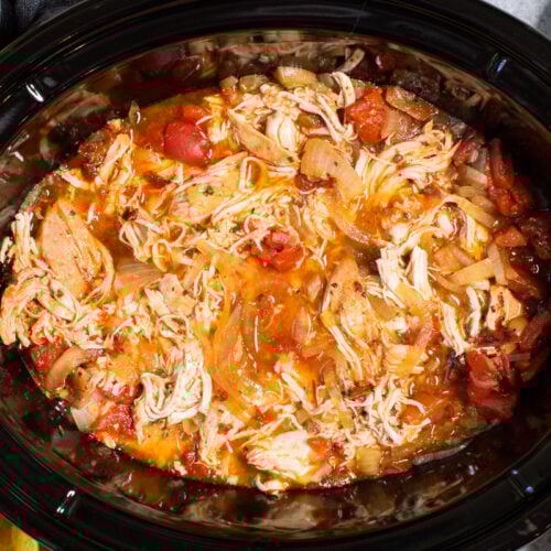 close up of shredded chicken tinga in slow cooker