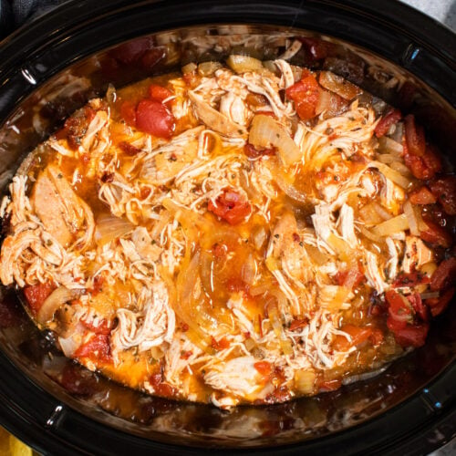 close up of shredded chicken tinga in slow cooker