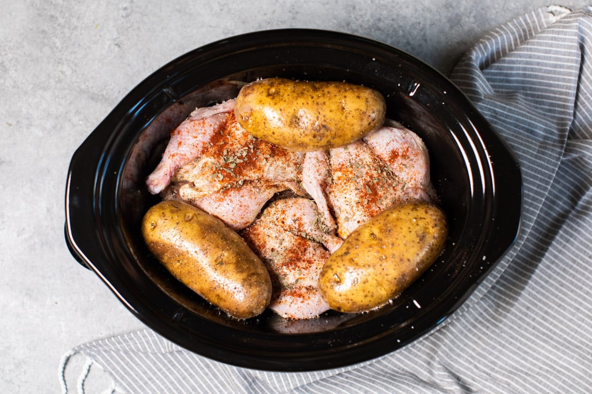 3 game hens, 3 potatoes with seasonings before cooking in slow cooker