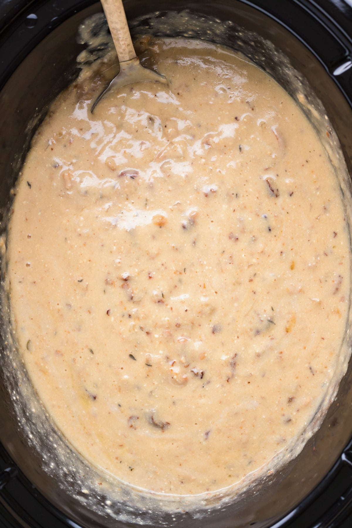 clam chowder in slow cooker with spoon in it