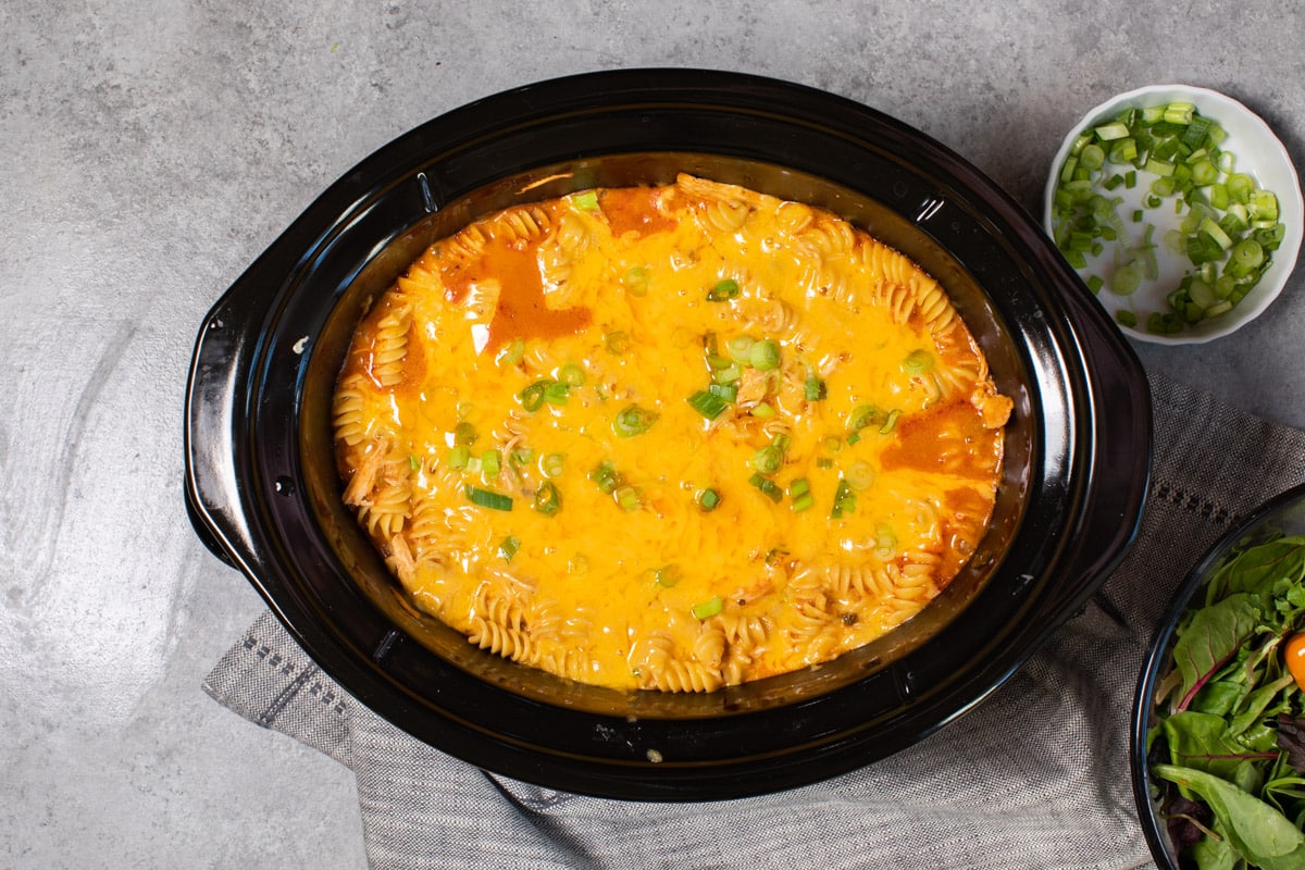 done cooking enchilada pasta in slow cooker with salad on side