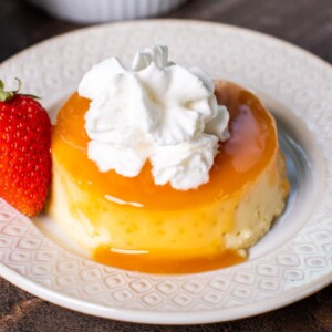 close up image of flan with whipped cream