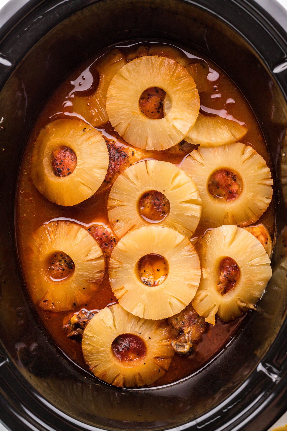 close up of barbecue pineapple chicken in slow cooker