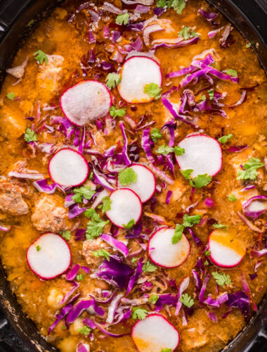 pozole in slow cooker with radish on top