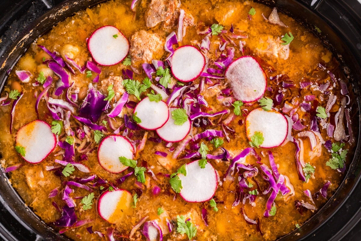 posole with radish and cilantro on top