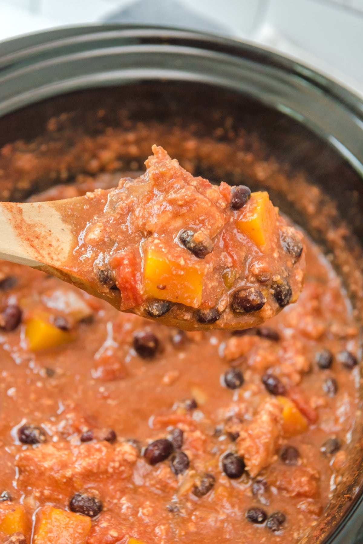 turkey butternut squash chili on wooden spoon