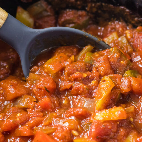 spoon in bell pepper pasta sauce in slow cooker