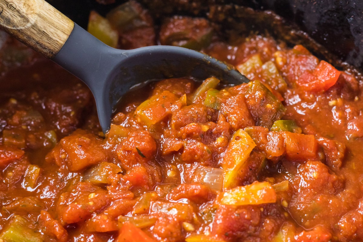 spoon in bell pepper pasta sauce in slow cooker