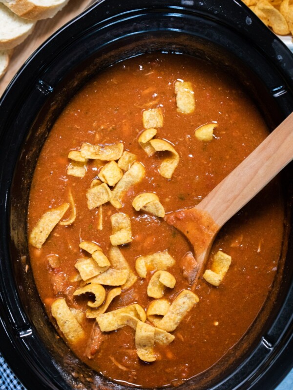 chili in slow cooker with frito chips on top