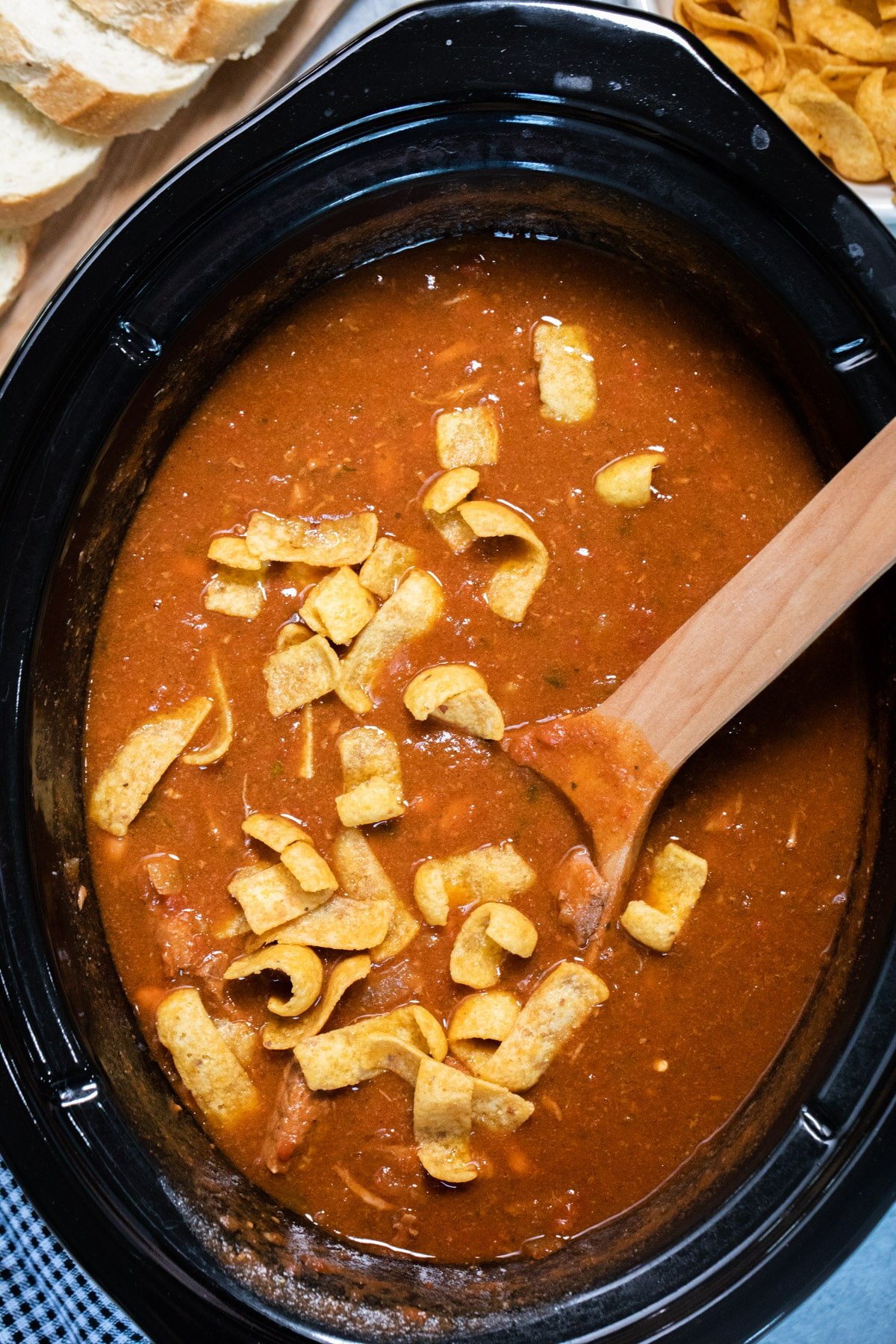 chili in slow cooker with frito chips on top