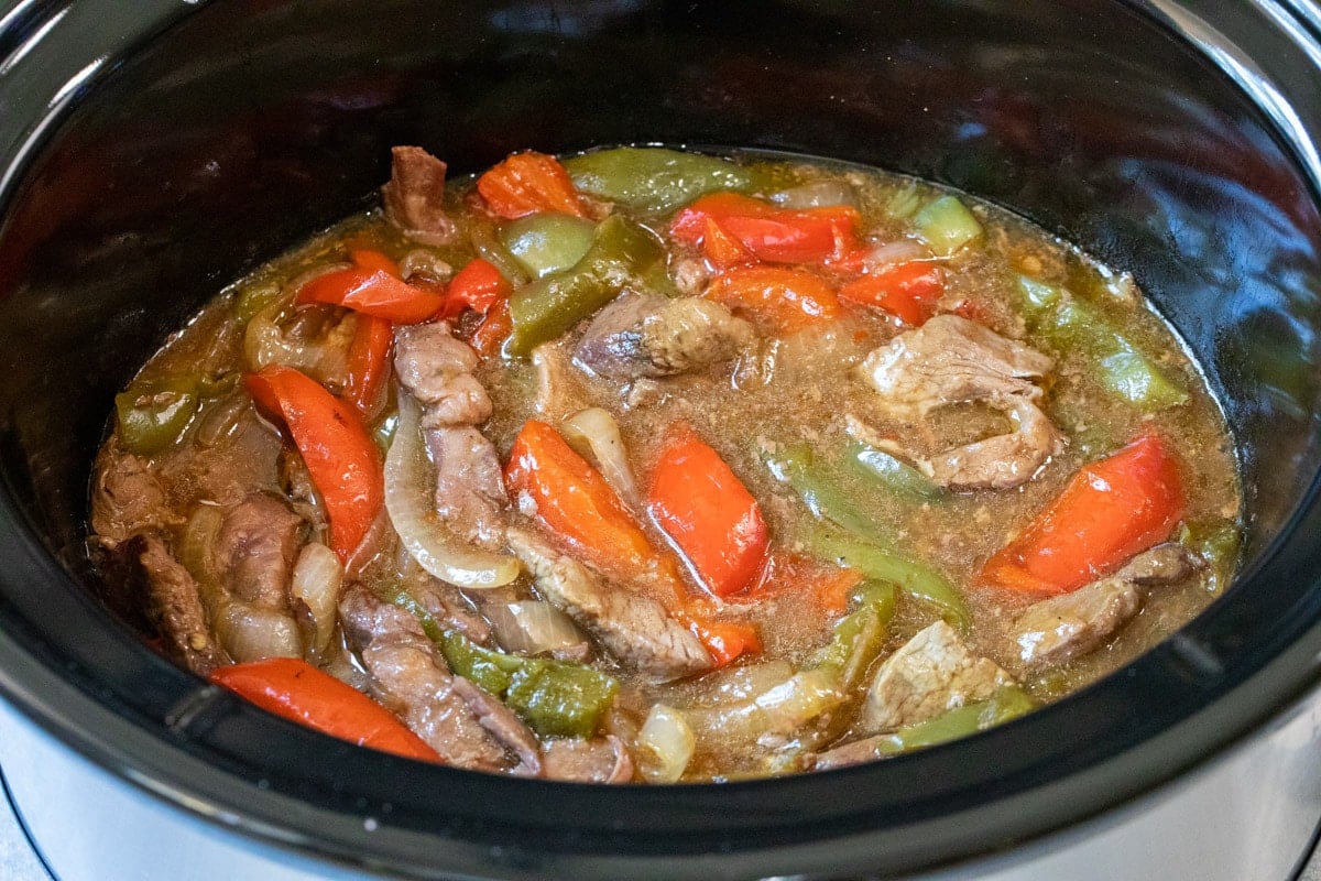 side view of pepper steak in slow cooker