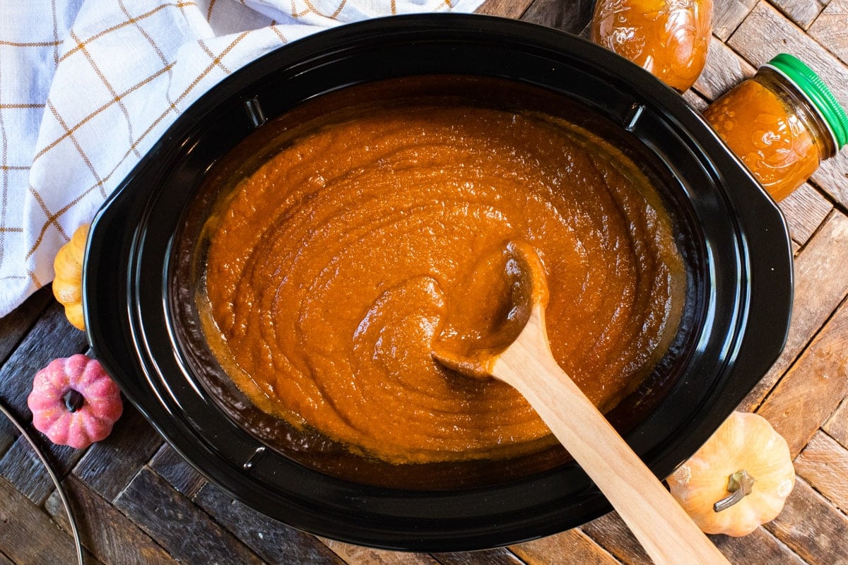 Cooked pumpkin butter with wooden spoon